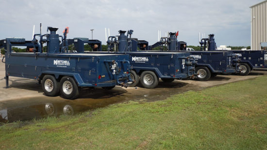 Blue Mitchell Industries gravel packing trailers in a row